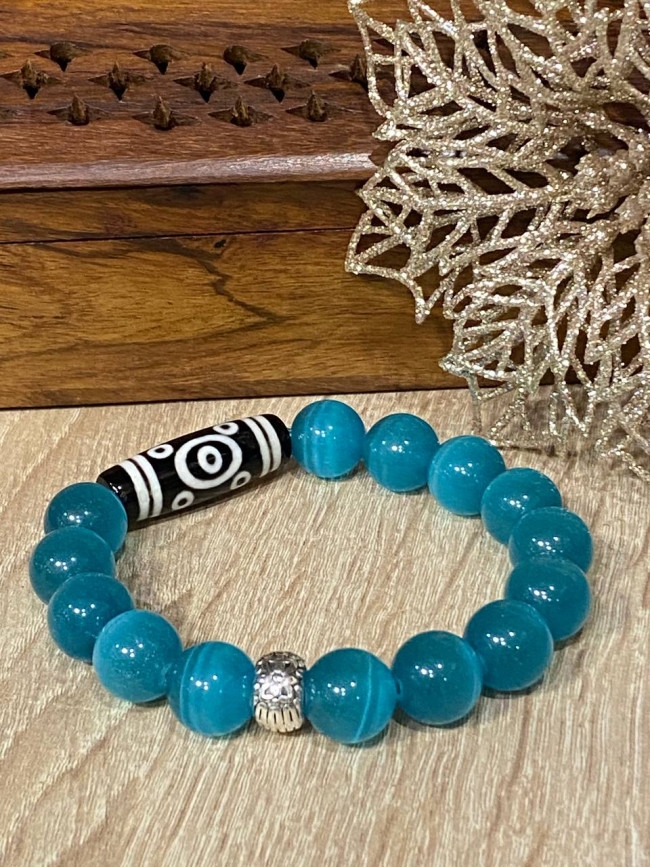 Бусина Дзи 13 глаз в браслете из голубого кошачьего глаза Бусина Дзи 13 глаз в браслете из голубого кошачьего глаза