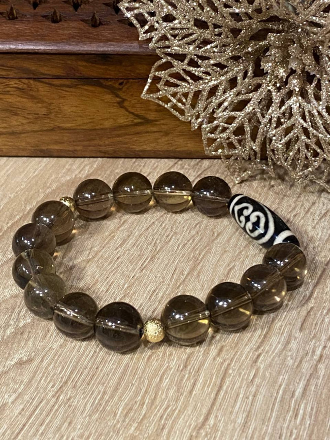 Бусина Дзи " Два сердца Будды" в браслете из раухтопаза Бусина Дзи " Два сердца Будды" в браслете из раухтопаза