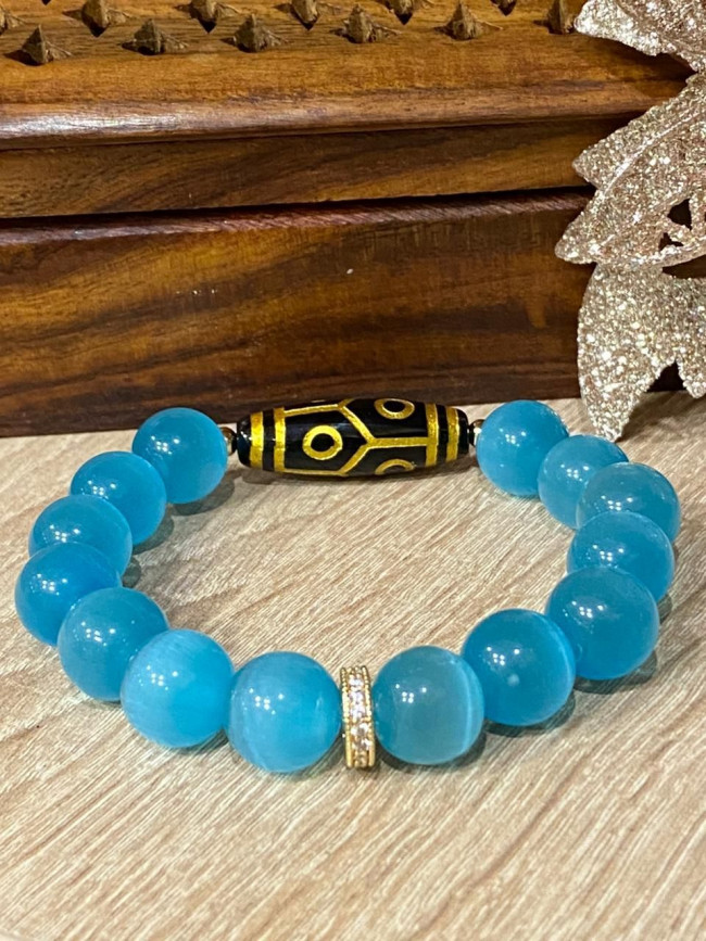 Бусина Дзи 6 глаз золотая в браслете из голубого кошачьего глаза 12 мм