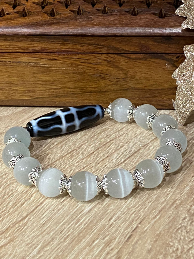 Бусина Дзи"Ваджра" в браслете из серого кошачьего глаза Бусина Дзи"Ваджра" в браслете из серого кошачьего глаза